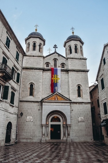 Serbian Orthodox church: A pseudo-Byzantine church with two bell towers is beautifully decorated religious structure with black domes, golden crosses, and large frescoes.
